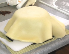 Marzipan draped over cake